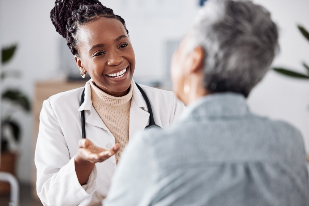 Doctor speaking to a woman whose back is turned away